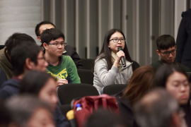 The audience shows keen interest in the Q&A session.